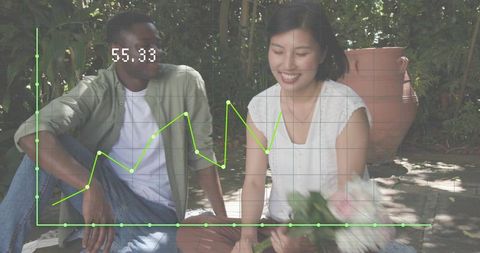 Couple sitting in garden holding bouquet with green chart overlay representing growth