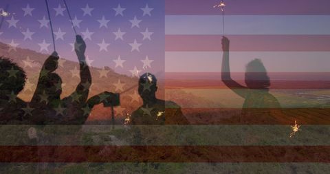 Celebrating with Sparklers Against American Flag Silhouette