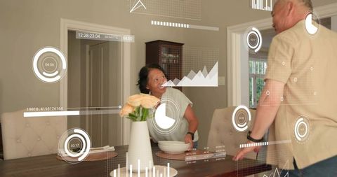 Senior couple interacting with augmented reality data overlays in modern dining room