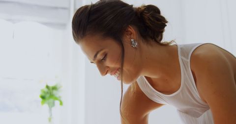 Joyful Bride in Elegant White Dress Preparing for Wedding Ceremony