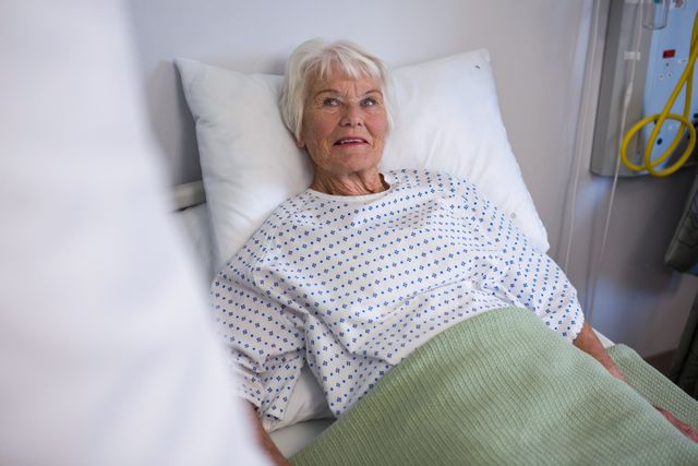 Senior patient lying on bed in hospital