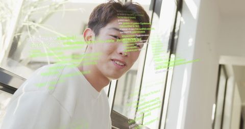 smiling man with overlay of programming code at home - Download Free Stock Images Pikwizard.com