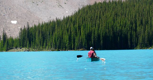 Solitary Person Paddling on Pristine Mountain Lake with Lush Forest Background - Download Free Stock Images Pikwizard.com