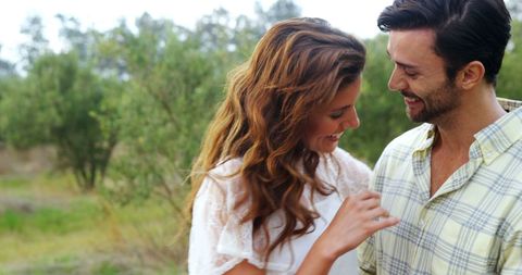 Smiling Young Couple Sharing Tender Moment in Nature - Download Free Stock Images Pikwizard.com