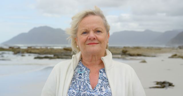 Smiling Senior Woman at Beach on Cloudy Day - Download Free Stock Images Pikwizard.com