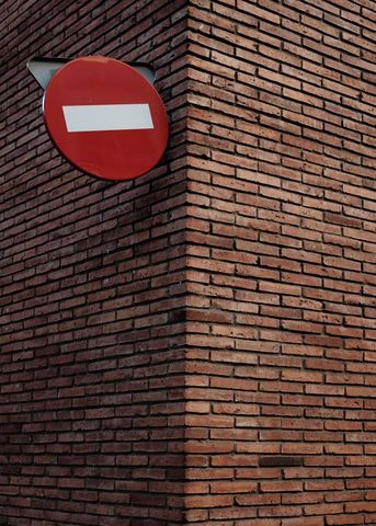 No entry sign on brick wall