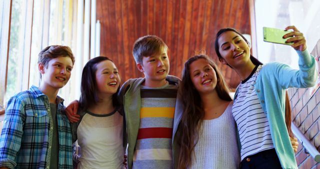 Group of friends taking selfie indoors on sunny day, displaying friendship, happiness. Ideal for social media, youth friendship, togetherness, positive vibes content.