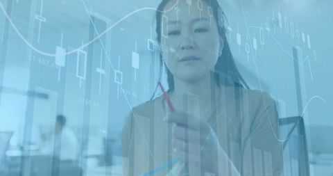 Asian Businesswoman Analyzing Data in Modern Office Environment