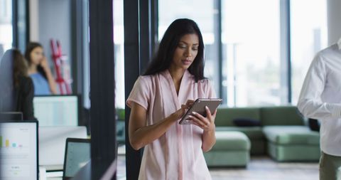 Confident Businesswoman Using Tablet in Modern Office Space - Download Free Stock Images Pikwizard.com