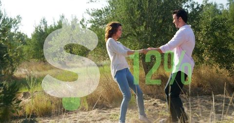 Couple holding hands spinning in sunlit orchard with 12% and dollar sign graphic overlay