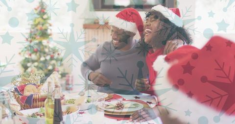 Joyful Family Celebrating Christmas with Festive Dinner and Santa Hats