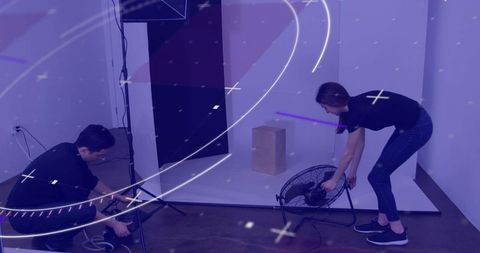 Behind the Scenes: Crew Setting Up Minimalist Photo Shoot Studio