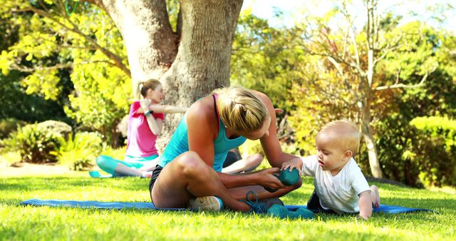 Mother Exercising with Baby in Sunny Park - Download Free Stock Images Pikwizard.com