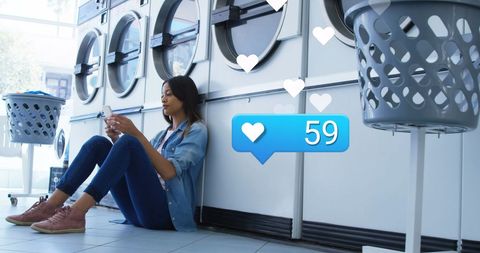 Young woman engaging with social media in laundromat setting