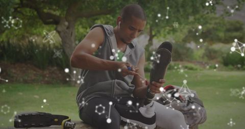 Athlete Adjusting Prosthetic with Digital Networks Background