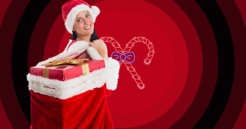 Festive woman carrying christmas gifts in santa costume