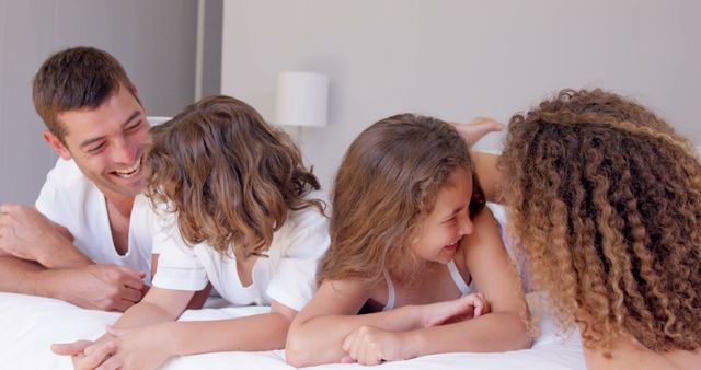 Happy Family Having Fun on Bed in the Morning - Download Free Stock Images Pikwizard.com