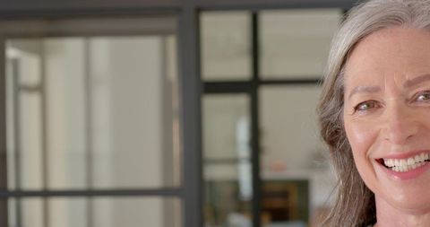 Senior Woman Smiling in Modern Office Environment