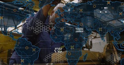 Machinist operating milling machine with digital world map overlay