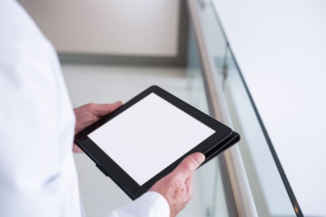 Close-up of doctor using a digital tablet in the passageway at hospital