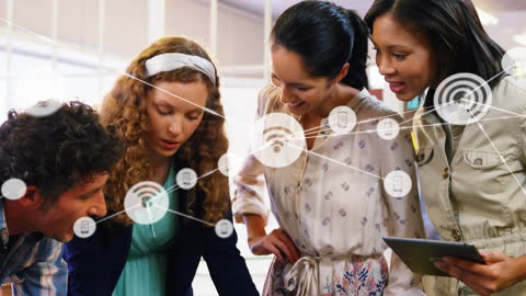 Multiracial Team Collaborating with Technology in Office