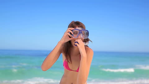 Smiling Woman Readying for Snorkeling on Sunny Beach