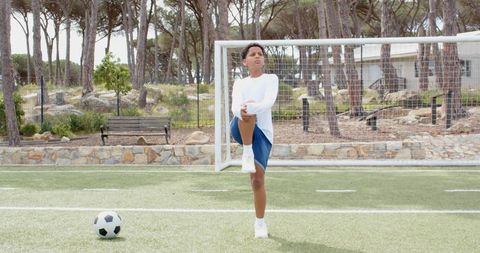 Young Boy Stretching in Soccer Field Relaxation and Focus