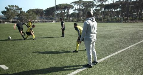 Soccer coach observing training session