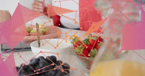 Cozy morning in coral cardigan with breakfast and digital network overlay