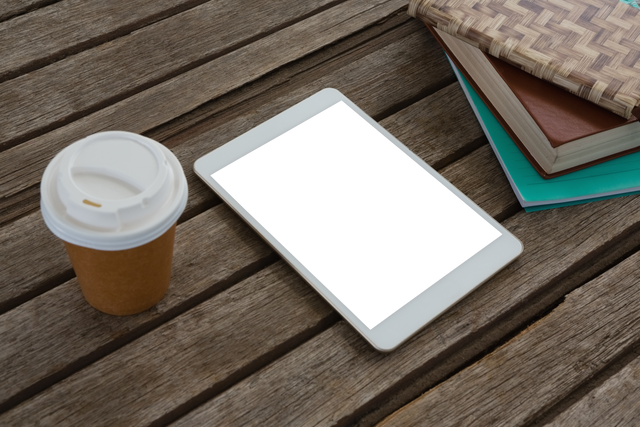 Transparent setup with tablet, books, coffee on rustic wooden table - Download Free Stock Videos Pikwizard.com