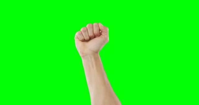 Raised fist of caucasian man, with copy space on green screen background. Communication, technology and digital interface, unaltered.