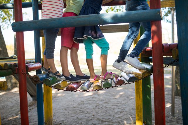 Low section of children walking on jungle gym at play ground