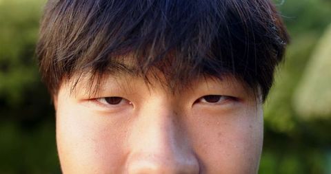 Close-Up Portrait of Young Man with Natural Lighting Outdoors