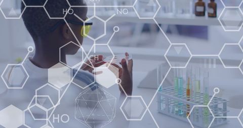 Young student examining petri dish in science lab