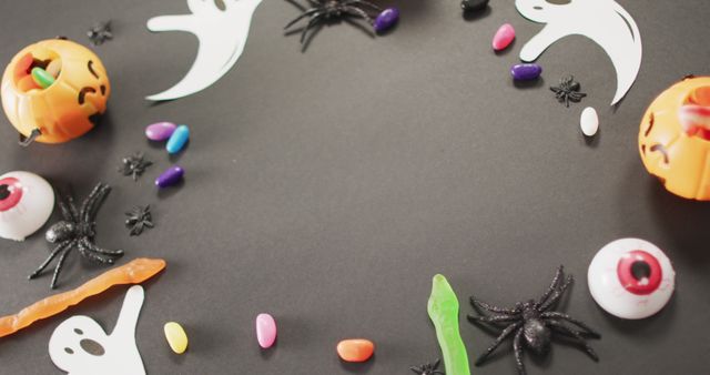 Multiple halloween toys and candies with copy space on grey background. halloween festivity and celebration concept