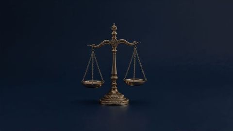 Ornate brass balance scale on dark blue background