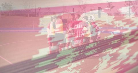 Players huddling on outdoor court with digital glitch overlay, athletes forming circle