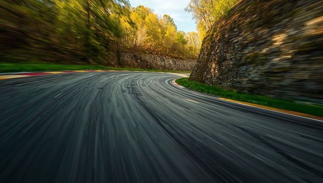 Dynamic Curved Mountain Road in Bright Countryside Landscape
