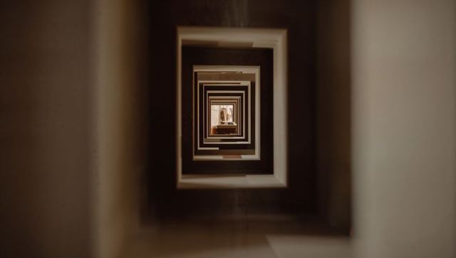 Concentric rectangular atrium tunnel creating deep geometric perspective and symmetry
