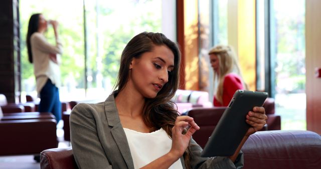 Professional Woman Using Tablet in Business Lounge - Download Free Stock Images Pikwizard.com