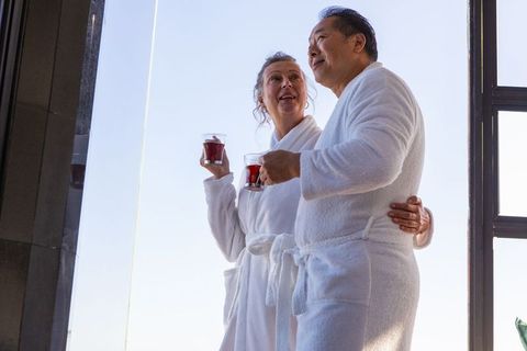 Senior Couple Enjoying Herbal Tea in Spa on Sunny Day