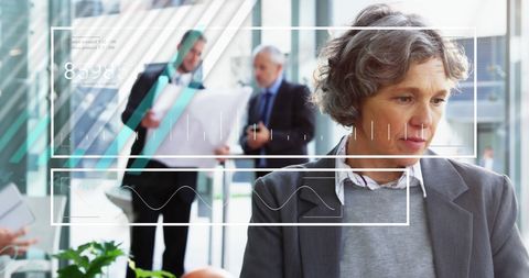 Caucasian woman analyzing digital data in modern workplace