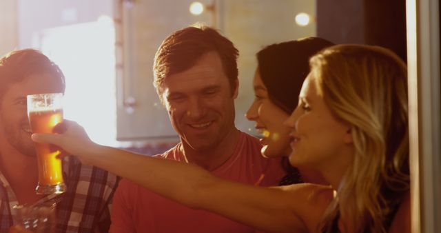 Group of friends enjoying drinks at a pub. Great for use in marketing materials for bars, nightlife events, social apps, or advertisements promoting social gatherings and friendship.
