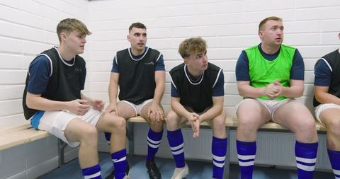 Soccer Team Discussing Tactics in Locker Room