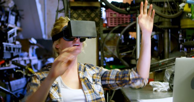 Young Woman Using Virtual Reality Headset in Garage Workshop - Download Free Stock Images Pikwizard.com