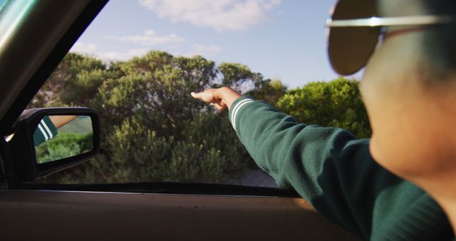 Person Pointing Out of Car Window at Nature Scene - Download Free Stock Images Pikwizard.com