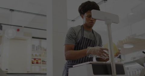 Grocery Store Employee Slicing Cheese at Modern Deli Counter