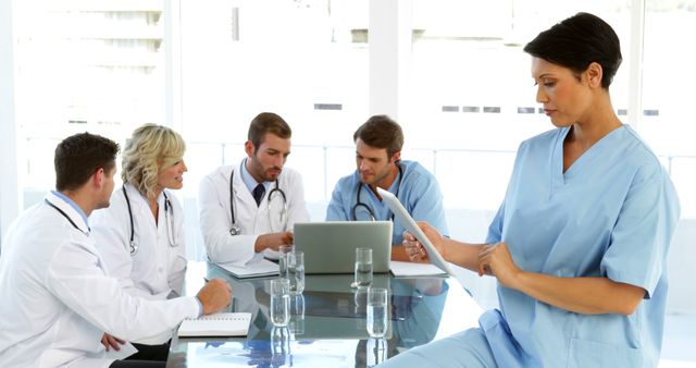 Multiracial Medical Team Reviewing Documents in Hospital Meeting Room - Download Free Stock Images Pikwizard.com