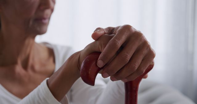 Elderly Woman's Hands Resting on Wooden Cane in Home - Download Free Stock Images Pikwizard.com