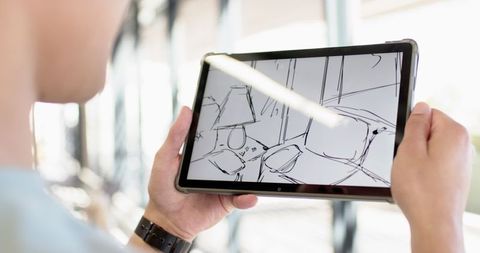 Designer creating monochrome interior on tablet